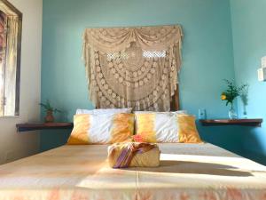 a bedroom with a bed with a large headboard at Vila Entreluas in Morro de São Paulo