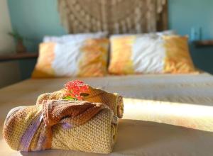 a toy horse on a table with two beds at Vila Entreluas in Morro de São Paulo +123 photos