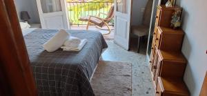 a bedroom with a bed with a towel on it at Christmas lights accommodation Vigo in Redondela