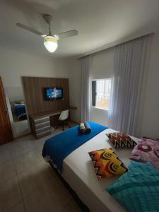 a bedroom with a bed and a television in it at Hostel Castelo in Belo Horizonte