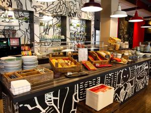 a buffet line with food on display in a restaurant at ibis Köln Messe in Cologne