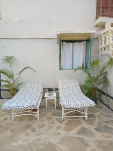 two chairs and a table on a patio at Tango house in Ukunda