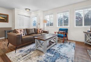 a living room with a couch and a table at Mountain Gate - Pet Friendly 2BR w Mountain Views and open hot tub in Canmore