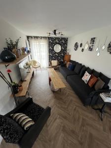 a living room with a couch and a table at Maison familiale 100m2 in Witry-lès-Reims