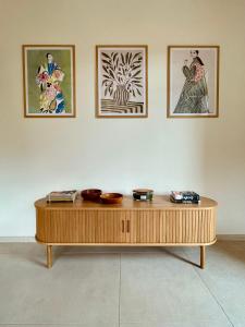 a wooden coffee table in a room with four pictures at Chata pod Jabloňou in Banská Štiavnica +38 photos