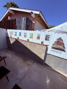 a fence with pictures on it in front of a house at Amarillo Lodge in Simi Valley