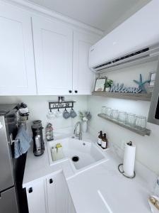 a white kitchen with a sink and a refrigerator at Private 1BR 1BA Suite, Kitchen, Fireplace, Parking in Simi Valley +26 photos