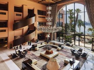 a large lobby with a chandelier and large windows at Sofitel Cairo Nile El Gezirah in Cairo