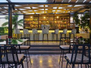 カイロにあるソフィテル カイロ ナイル エル ゲジラの椅子とテーブルのあるバーのあるレストラン