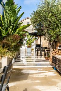a patio with tables and chairs and plants at Simple La Jolla Epic bungalow #7 in San Diego