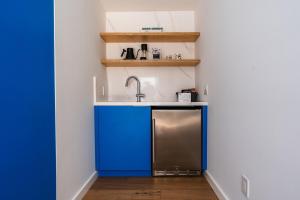 a kitchen with blue cabinets and a sink at Simple La Jolla Epic bungalow #7 in San Diego +10 photos