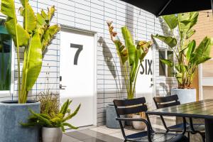 a white door with a table and chairs and plants at Simple La Jolla Epic bungalow #7 in San Diego