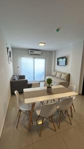 a living room with a table and chairs and a couch at Departamento Bitcoins House Rivadavia in Corrientes