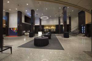 a lobby with a table in the middle of a building at NH Pamplona Iruña Park in Pamplona +41 photos
