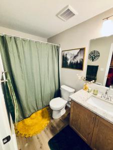 a bathroom with a toilet and a sink and a shower at Colorful Comfort 3 Bedroom Home with Fenced yard in Vancouver +33 photos