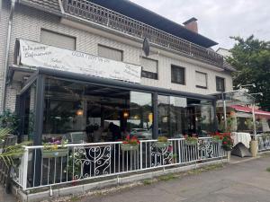 a restaurant with a sign on the side of a building at Restaurant Hotel Friesdorfer Hof in Bonn