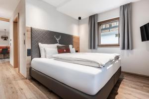 Postel nebo postele na pokoji v ubytování Avero Lodge by MEIN SAMNAUN - MOUNTAIN HOMES + 25 fotografií