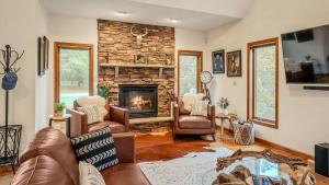 a living room with a couch and a fireplace at Entertainers Home w Deck Game Room Hot Tub Lake View Retreat by AvantStay in Albrightsville