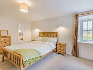 a bedroom with a large bed and a window at 3 Bed in Kirriemuir 37440 in Kirriemuir