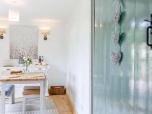 a kitchen with a table and a glass shower at 1 bed in Chulmleigh 82389 in Chulmleigh +7 photos