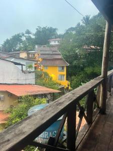 a view from the balcony of a yellow house at Flat Serena in Cayru