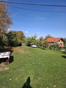 a shadow of a person standing in a yard at Kućica na žaru in Čačak