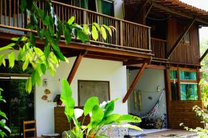 a tree house with a balcony at Barra Quintal - Studio 2 in Barra Grande +8 photos