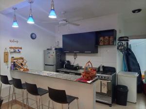 a kitchen with a counter top and a stove top oven at Casa de 3 recámaras - Ibiza Beach House - 6153-4630 in Río Hato