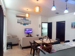 a living room with a table and a couch at Casa de 3 recámaras - Ibiza Beach House - 6153-4630 in Río Hato