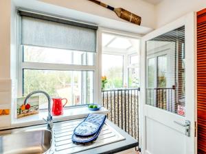 a kitchen with a sink and a window at 1 bed in Filey 77710 in Hunmanby +28 photos