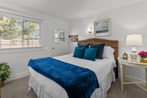 a bedroom with a large bed with blue pillows at The American House in Williams Bay in Lake Geneva