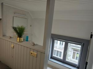 a room with a window and a plant on a counter at Chambre équipée pour 2p in Ostend