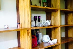 a wooden shelf with many different items on it at Barra Quintal Studio 3 in Barra Grande +11 photos