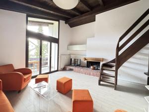 a living room with a couch and a fireplace at Casa Laret 6-12 in Laax-Murschetg