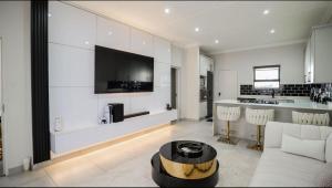 a living room with a couch and a table at LiFa Luxury Sandton Retreat in Johannesburg