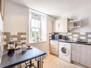 a kitchen with a washer and dryer in it at 2 bed in Berwick Upon Tweed 81273 in Berwick-Upon-Tweed +10 photos