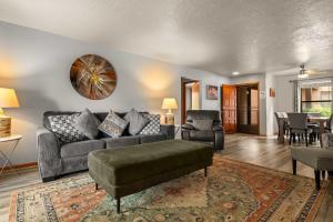 a living room with a couch and a table at Charming Sedona Stay with Community Spa & Pool in Sedona