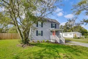 a gray house with a tree in the yard at Beach Days and Dtwn Charm! Cape Charles Cottage in Cape Charles