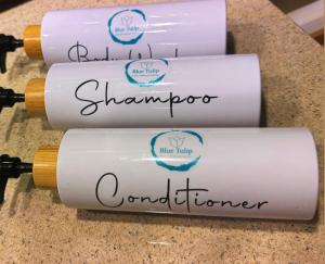 a group of three wine bottles on a counter at Blue Tulip - Strovolos in Kato Lakatamia