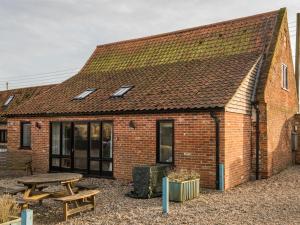 a brick building with a picnic table in front of it at 3 Bed in Briston KT187 in Briston