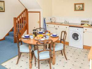 cocina con mesa de madera con sillas y fregadero en 2 Bed in Blackwater IC082, en Newport