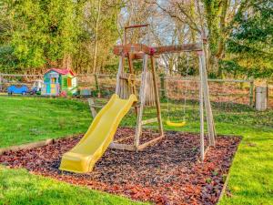 a playground with a slide in a yard at 3 Bed in Wareham 76648 in East Stoke