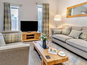 a living room with two couches and a television at 2 Bed in Croes-y-pant 58961 in Mamhilad