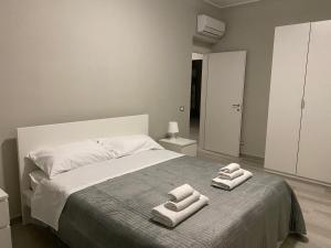 a bedroom with a bed with two towels on it at SUPREME Rooms in Reggio Calabria
