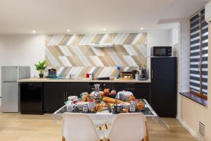 a kitchen with a table with food on it at LE CONCORDE-WIFI-Clim-Parking-3étoiles-OcKeys in Bram