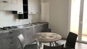 a kitchen with a table and chairs and a counter at SUPREME Rooms in Reggio Calabria