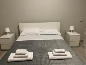 a bedroom with a bed with towels on it at SUPREME Rooms in Reggio Calabria