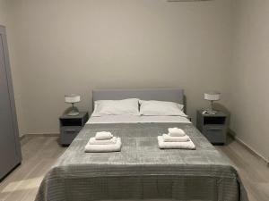 a bedroom with a bed with towels on it at SUPREME Rooms in Reggio Calabria