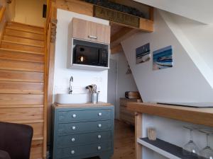 a tiny kitchen with a sink and a microwave at L'ANEDA Vue sur mer - COCCONING 2 Personnes - 3ème étage in Mers-les-Bains