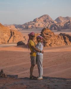 a man and a woman standing in the desert at Camp in the natural reserve & tours in Aqaba